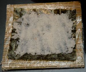 Cover the entire nori with rice evenly. Leave space around the edges.